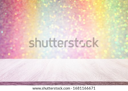 Photo of old wooden table in front of pastel rainbow glitter lights background. Ready for product display montage.