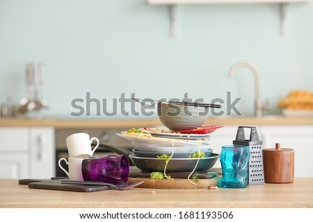 Dirty dishes on kitchen table Royalty-Free Stock Photo #1681193506