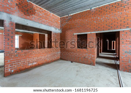 Concrete construction of basement of large building. Ground floor Inside the modern construction site in a mix of fluorescent and natural lights. Contemporary structure under construction with concret