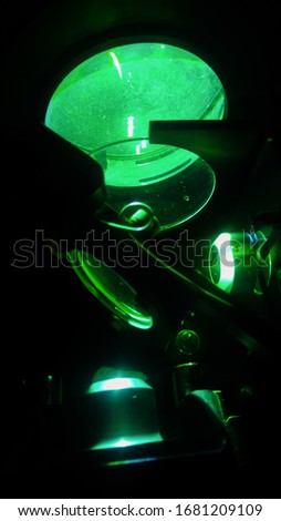 Mirrors and precision lenses of a interferometer, an advanced scientific equipment in a French laboratory of wave optics, used in green light with a spectrum filter and a mercury lamp