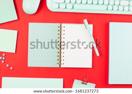 flat lay stationery on work desk in red pastel background