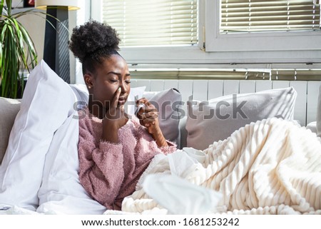 Woman is having flu and she is using nasal spray to help herself. Woman using nasal spray. Nasal spray to help a cold. Sick with a rhinitis dripping nose. Woman applies nasal spray