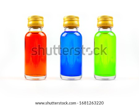 Food coloring in glass bottles on white background isolate, yellow, blue, green, three bottles of food coloring  Royalty-Free Stock Photo #1681263220