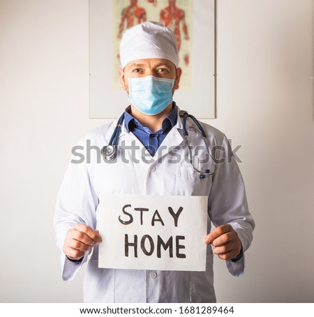 Doctor holding STAY HOME sign. Begging People with hashtag #StayHome to Fight Coronavirus. Anti nCoV Covid-19 Virus