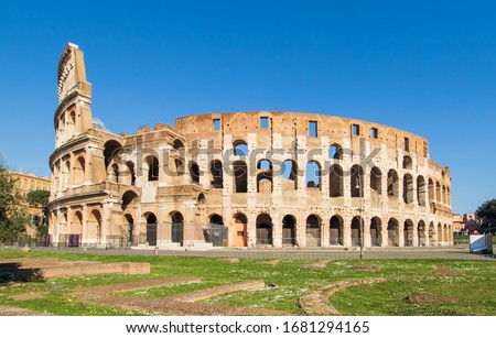 Following the coronavirus outbreak, the italian Government has decided for a massive curfew, leaving even the Old Town, usually crowded, completely deserted. Here in particular the Colosseum Royalty-Free Stock Photo #1681294165