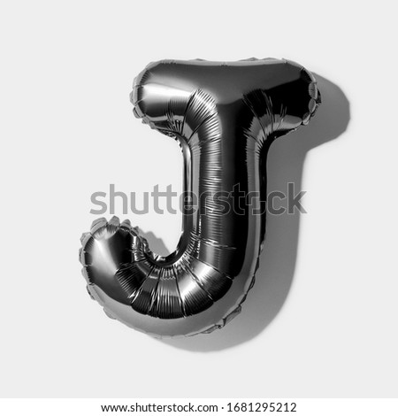 Letter J, Black foil balloon alphabet isolated on a white background with Clipping Path