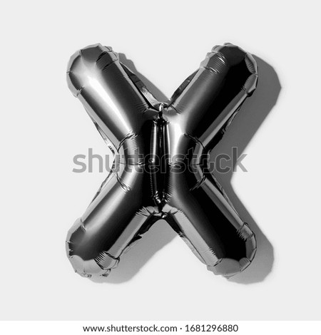 Letter X, Black foil balloon alphabet isolated on a white background with Clipping Path