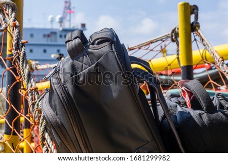 Luggage of an offshore worker inside a basket onboard a crew boat leaving oil field for a crew change Royalty-Free Stock Photo #1681299982