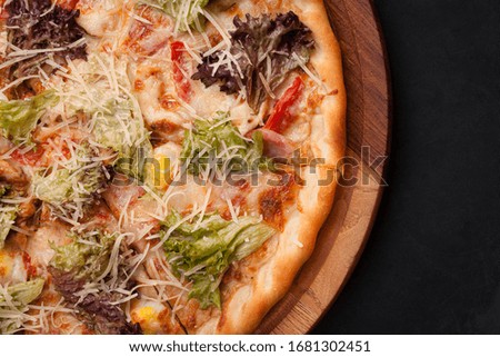 Ready-made appetizing pizza close-up. Stock photo pizza on a wooden table.