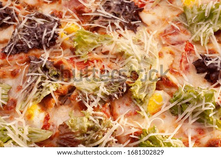 Ready-made appetizing pizza close-up. Stock photo pizza on a wooden table.