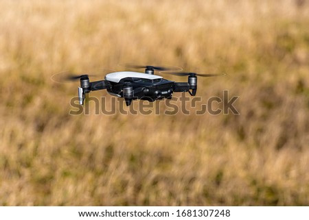 Close-up view of drone flying over agricultural field in spring, technology innovation in agricultural industry