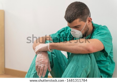 Coronavirus pandemic . Tired exhausted doctor after long shift fighting against Coronavirus (2019-nCoV) at hospital clinic. Global pandemic outbreak SARS-CoV-2 worldwide virus. Royalty-Free Stock Photo #1681311784