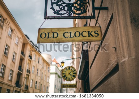 Old clock sign hanging in the street