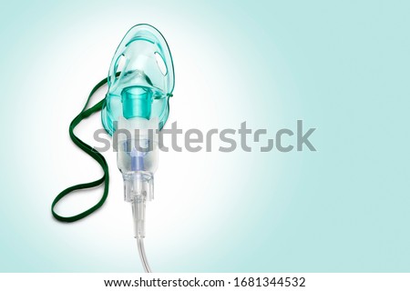 Close up image of an oxygen mask from front on green gradient. Clipping path for the mask Royalty-Free Stock Photo #1681344532
