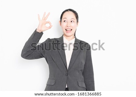 Woman making OK sign shot in studio