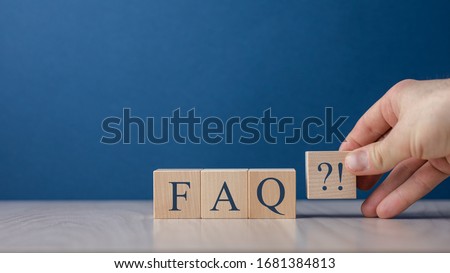 Businessman puts wooden blocks with the word FAQ (frequently asked questions). Collection of frequently asked questions on any topic and answers to them. Instructions and rules on Internet sites Royalty-Free Stock Photo #1681384813
