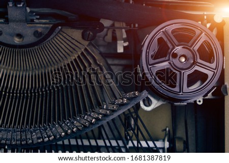 Mechanism and keyboard of an old typewriter with a film coil. Bright sunlight
