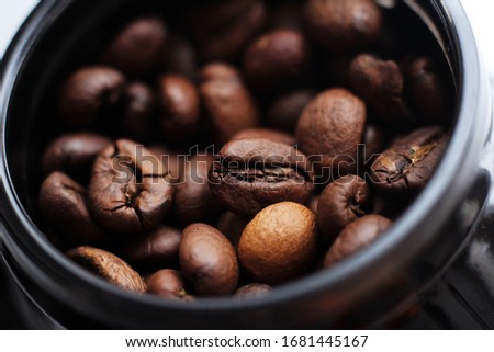 Coffee beans in a black jar so close