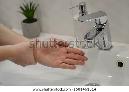 Washing of hands with soap under running water. Hygiene. Hand washing rules. Medical hand washing. Stay home. Covid-19 outbreak concept. Coronavirus epidemic protection. Washing hands in the bathroom
