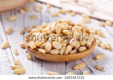 Pine nuts on a white board Royalty-Free Stock Photo #1681467223