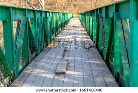 Wooden bridge with metal handrails