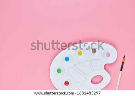 Art of sweetmeats concept, copy space. Sweet candy in paint palette on pink background. Love to colorful sweetmeats in childhood and cooking sweets