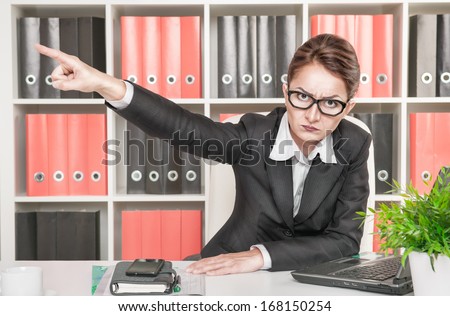 Angry woman boss pointing out Royalty-Free Stock Photo #168150254