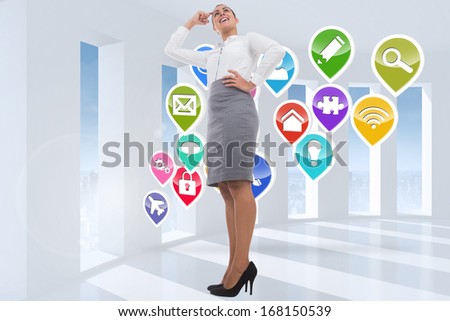 Smiling thoughtful businesswoman against stack of books