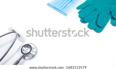 Green gloves Mask And the stethoscope Placed on a white background with a copy space taken at the top corner.