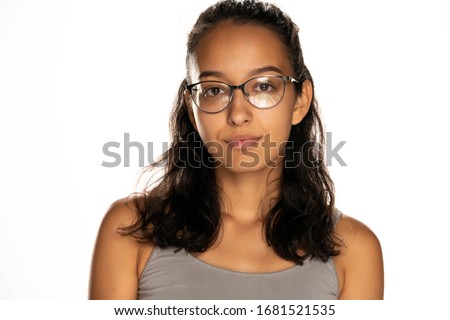 portrait of serious young arabic woman with glasses on white background