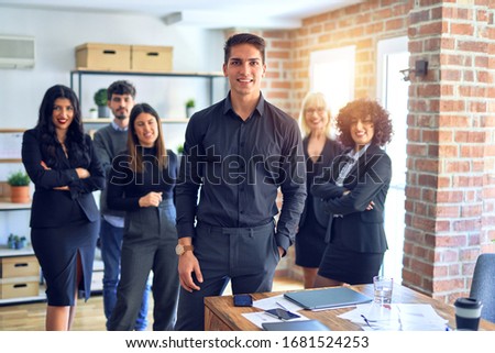 Group of business workers smiling happy and confident. Posing together looking at the camera, young handsome man with smile on face at the office