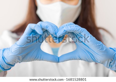 Stop SARS-CoV, SARSCoV, virus 2020 , MERS-CoV ,chinese virus COVID-19. Closeup womens hand in blue medical gloves show heart sign. Concept of protection against HIV. Doctor in blue medical gloves and Royalty-Free Stock Photo #1681528801