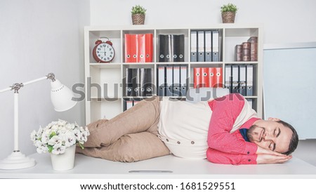Funny retro style business man sleeping on the table in office