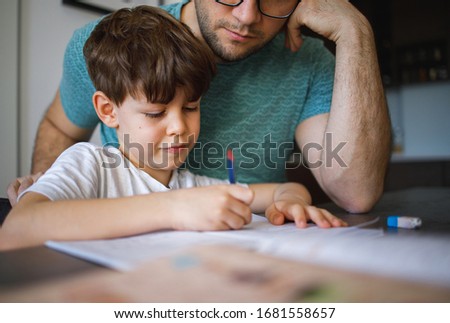 Young Father homeschooling his son Royalty-Free Stock Photo #1681558657