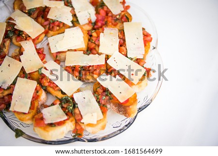 Elegant bruschetta display of ciabatta bread, mozzerella cheese, diced tomato and fresh basil
