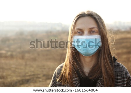 close up of Photo of a woman wearing protective mask against infectious diseases, coronavirus, covid-19 and flu outdoors. copy space. Coronavirus outbreak in Europe. Flu epidemic spread prevention
