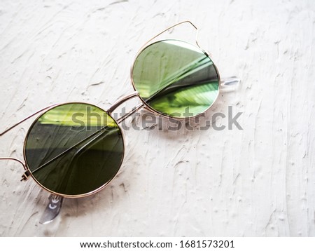 green glasses on the background of concrete plaster with reflection, a place for designer.