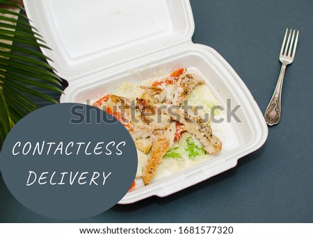 salad n a box and the inscription contactless delivery. Delivery of the product during quarantine. 