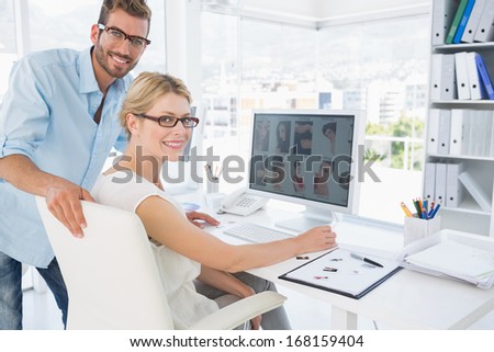 Side view portrait of photo editors working on computer in a bright office