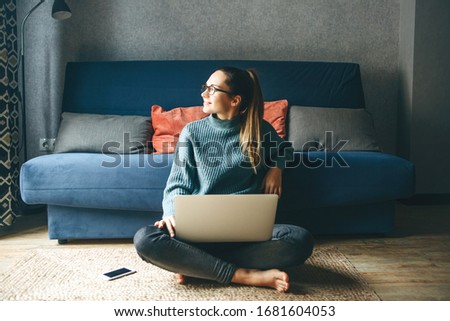 Girl working on laptop from home or student studying from home or freelancer. Or she is watching a video or using the Internet Royalty-Free Stock Photo #1681604053