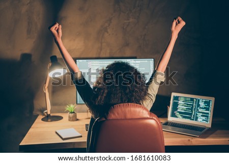 Back rear spine view photo delighted crazy afro american girl successful hacker write binary code artificial intelligence international server raise fists scream yes in workstation workplace