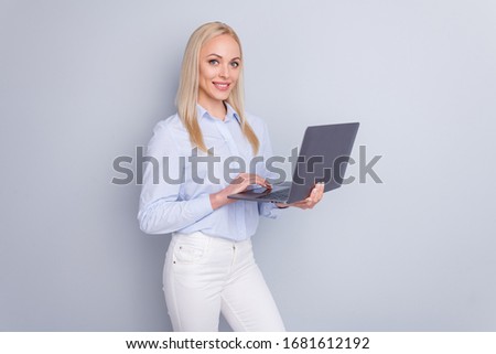 Photo of positive intelligent manager girl hold laptop ready prepare company document search information wear good look pants isolated over gray color background