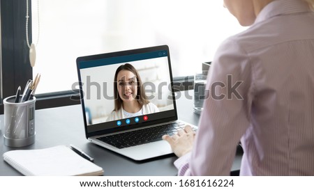Back view of female talk consult with psychologist or colleague use webcam conference on laptop, woman speak on virtual video call with business partner or client, online consultation concept Royalty-Free Stock Photo #1681616224