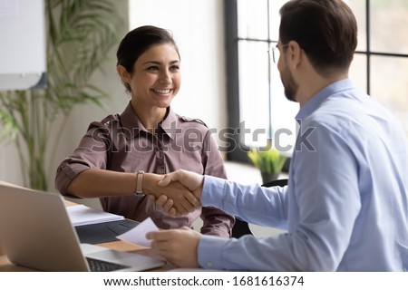 Happy multiracial businesspeople shake hands at meeting greeting getting acquainted, smiling diverse business partners handshake close deal make agreement after successful negotiation or briefing Royalty-Free Stock Photo #1681616374