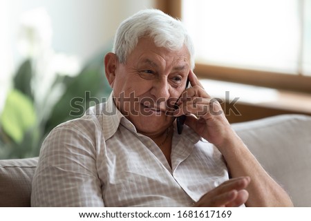 Smiling older man talking on cellphone close up, happy grandfather chatting with relatives or grandchildren, satisfied mature male making or answering phone call, having pleasant conversation Royalty-Free Stock Photo #1681617169