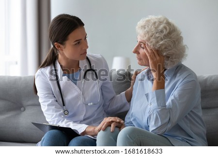 Supportive female nurse visit old grandmother patient at home listen to complains concerns, attentive young woman doctor consulting mature senior grandma, elderly medical healthcare concept Royalty-Free Stock Photo #1681618633