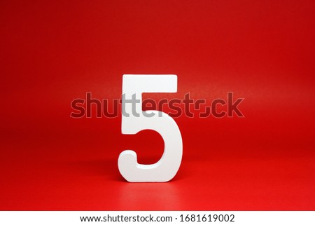 Five ( 5 ) white wooden number Isolated Red Background with Copy Space - New promotion 5% Percentage  Business finance Concept