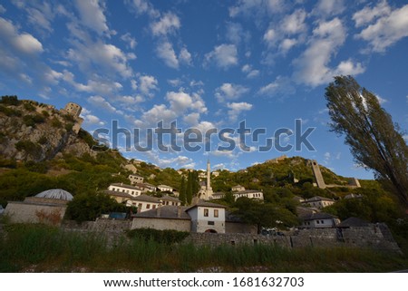Under the blue sky and clouds, and the castles, minarets, buildings on the hillside. At Počitelj city,Bosnia and Herzegovina .In September 2019.