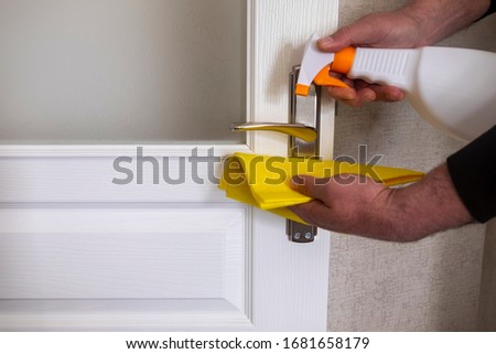 To protect against Covid-19 virus, we must clean the door handles with disinfectant. corona virus. Royalty-Free Stock Photo #1681658179