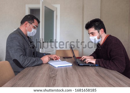 Men working in the office wear masks to protect against covid-19. coronavirus Royalty-Free Stock Photo #1681658185